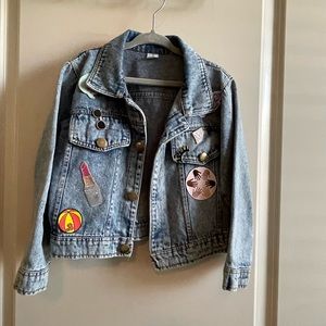 Jacket decorated with cute iron on patches and girly pins.